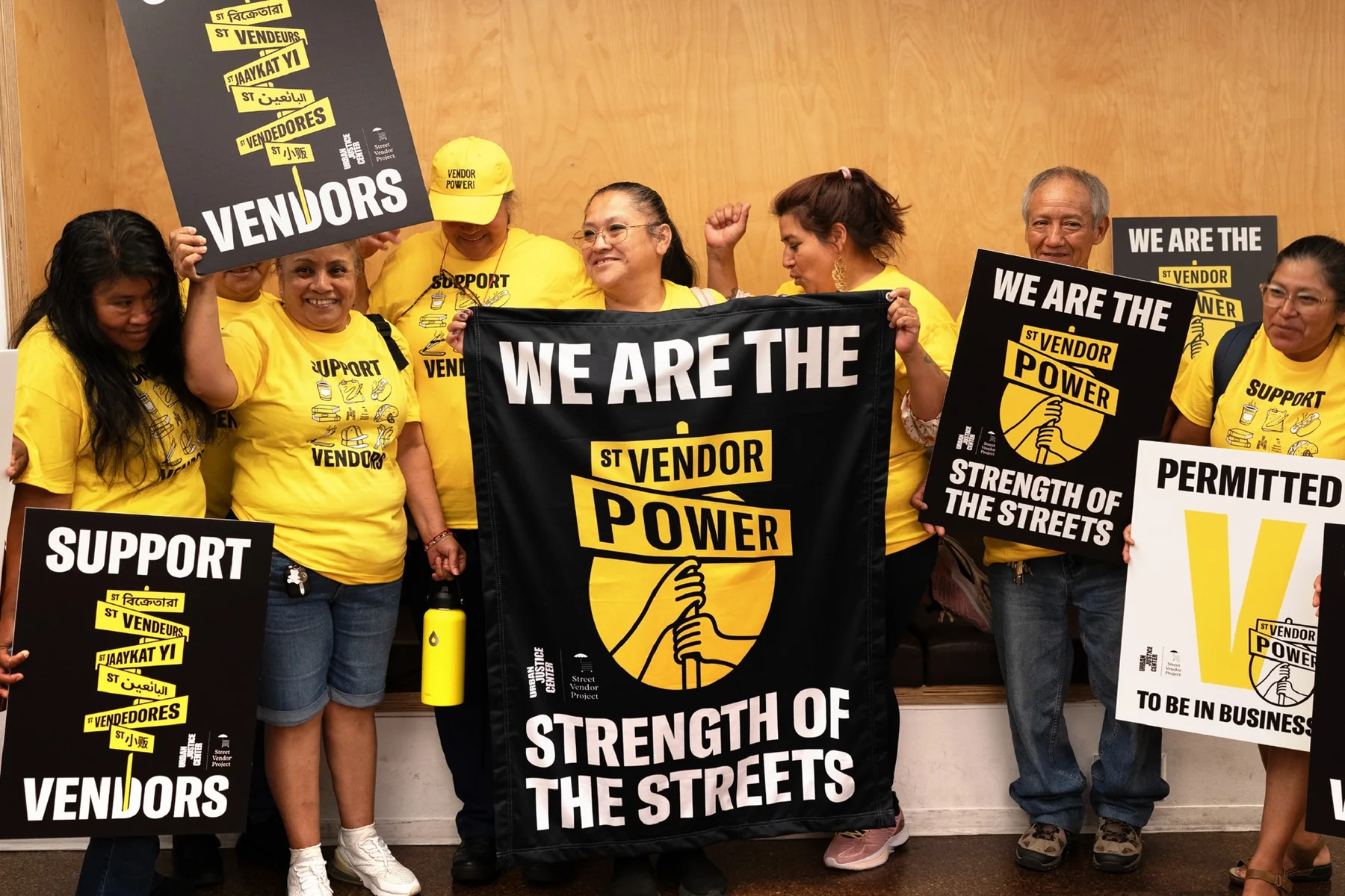 Street Vendor Project community members with Strength of the Streets graphics