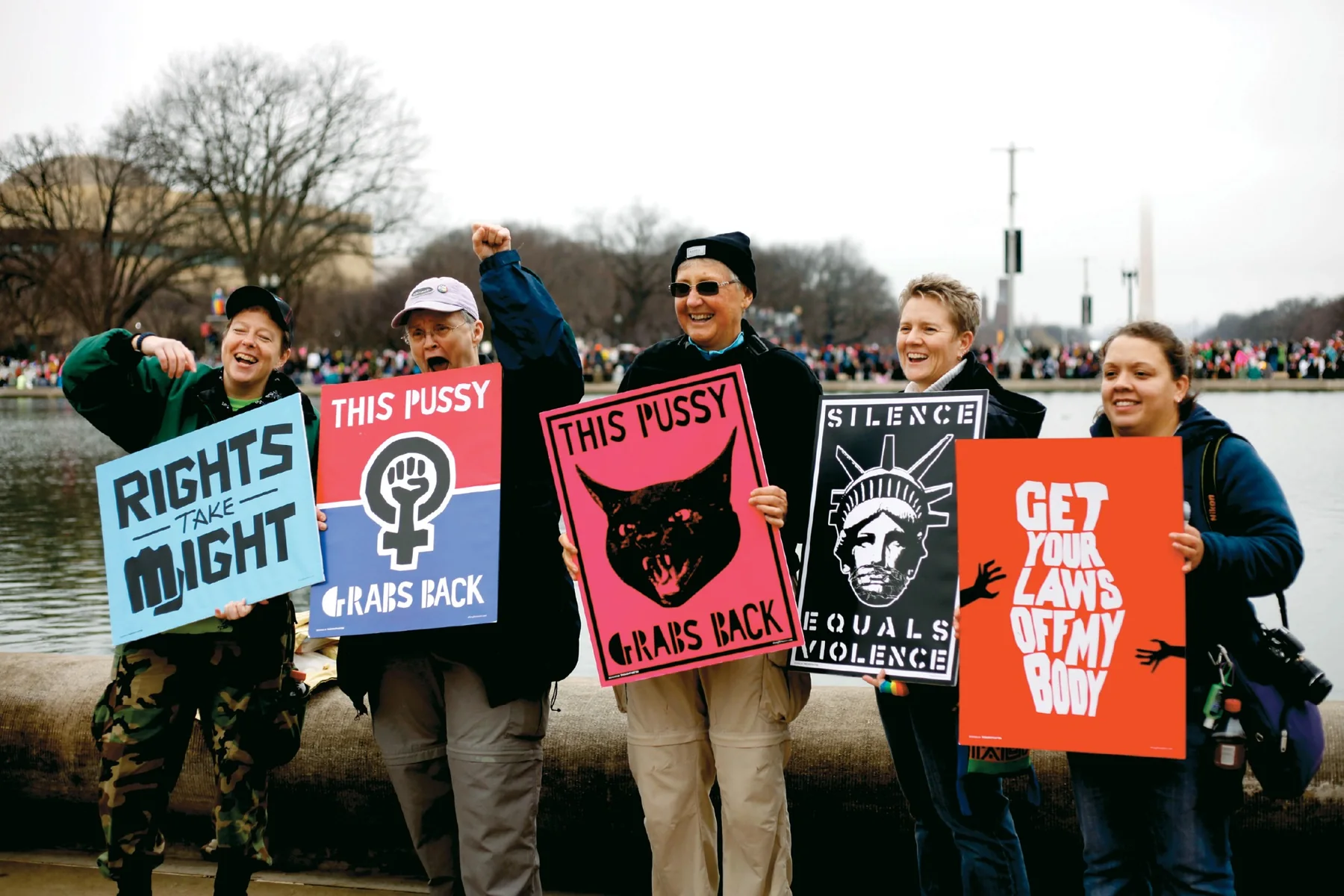 Women’s March participants holding protest posters